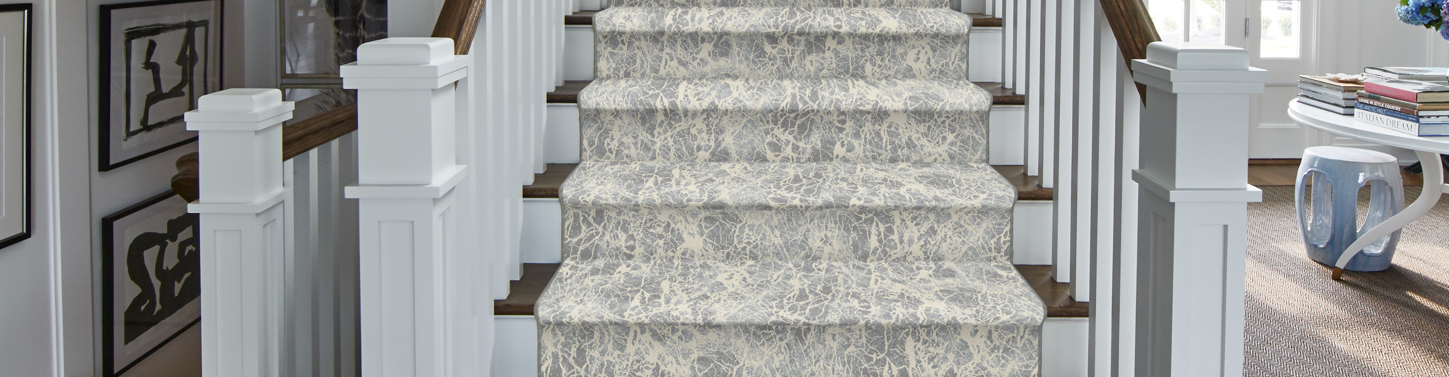 Patterned carpet on hardwood stairs. 